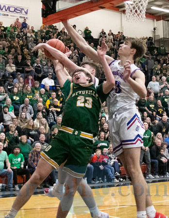 Ottoville's Carter Horstman (#23) shoots as the shot is blocked