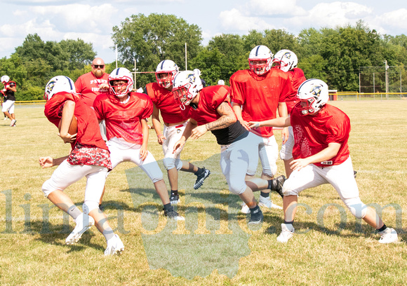 Perry's Head Football Coach, Seth Evans, oversees a practice scrimmage on Mon