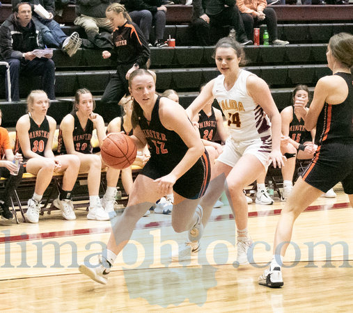 Minster's Lydia Mescher (#12) takes the ball down the court foll